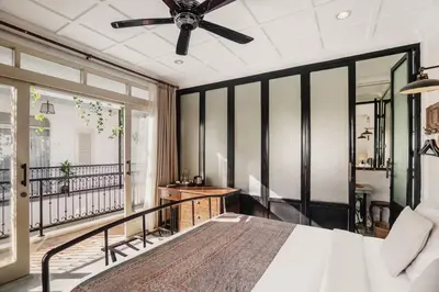 a bedroom with a bed and a ceiling fan at Brown Feather Batu Belig in Seminyak