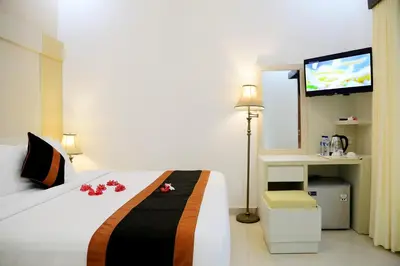 a hotel room with a bed and a television at Kaniya bali in Nusa Dua