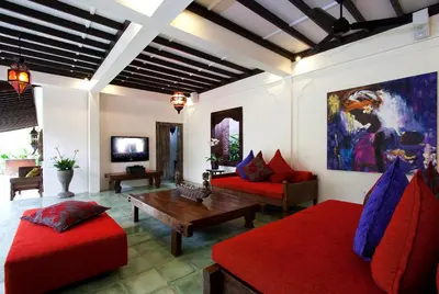 a living room with two red couches and a table at Villa Jumah in Seminyak