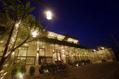 a building with bikes parked outside of it at night at Seminyak Lagoon All Suites Hotel in Seminyak