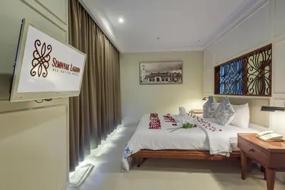 a hotel room with a bed and a sign on the wall at Seminyak Lagoon All Suites Hotel in Seminyak