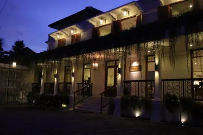 a building with christmas lights on it at night at Seminyak Lagoon All Suites Hotel in Seminyak