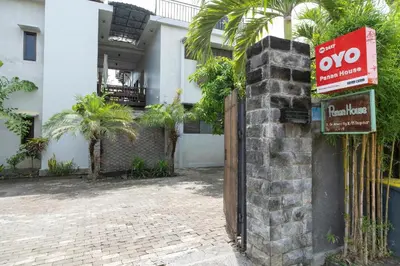 a sign on a fence in front of a building at Hotel O Panen House in Seminyak