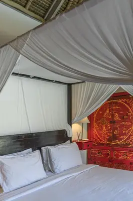 a bedroom with a white bed with a canopy at Villa Palm Tree - Huge 4bd Villa CENTER SEMINYAK in Seminyak