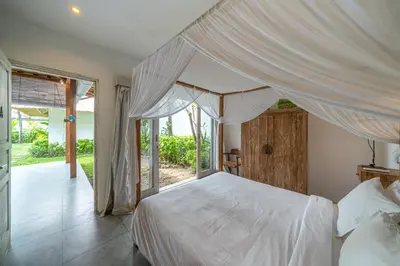 a bedroom with a white bed with a canopy at Villa Palm Tree - Huge 4bd Villa CENTER SEMINYAK in Seminyak
