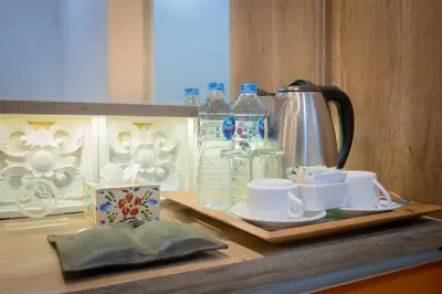 a kitchen counter with a tea kettle and cups on a tray at The Nyaman Hotel Bali in Kuta