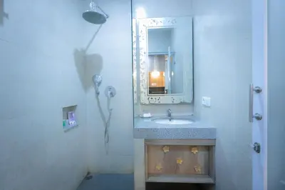 a bathroom with a sink and a mirror at The Nyaman Hotel Bali in Kuta