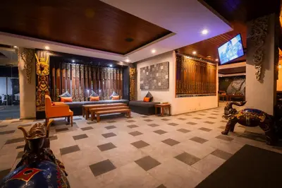 a living room with a couch and a tv at The Nyaman Hotel Bali in Kuta