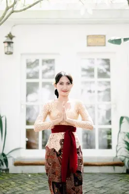 a woman standing in front of a building at Umalas Suites in Seminyak