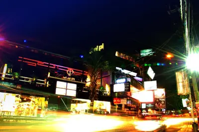 a busy city street at night with traffic at Bemo Corner Guest House in Kuta