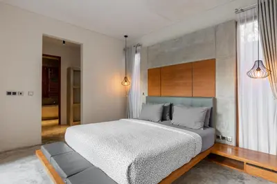 a bedroom with a large bed and a couch at SooBali Niscala Villa 5 Bedroom in Canggu
