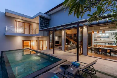 a house with a swimming pool and a dining area at SooBali Niscala Villa 5 Bedroom in Canggu