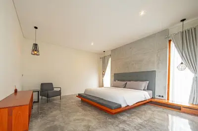 a bedroom with a bed and a desk and a chair at SooBali Niscala Villa 5 Bedroom in Canggu