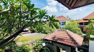 a view of a house with a red roof at Villa Diana Bali in Legian