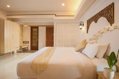 a bedroom with a large white bed in a room at Alindra Villas & Spa in Nusa Dua