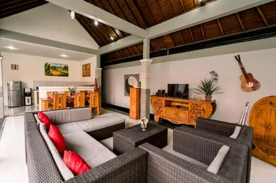 a living room with a couch and a table at Taman Bali Villas Dewi Sri in Legian
