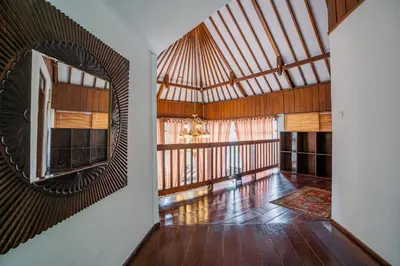 a room with a large mirror and a wooden ceiling at Nipper Villa - Spacious 4BR in Canggu in Canggu
