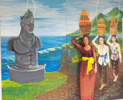 a woman standing next to a statue in front of a mural at Bali Bobo Hostel in Jimbaran