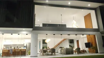 a living room and dining room in a house at The Jendela House in Canggu