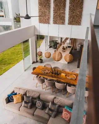 an aerial view of a living room with a wooden bench at The Jendela House in Canggu