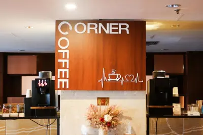 a sign for a corner store in a building at The Kuta Beach Heritage Hotel - Managed by Accor in Kuta