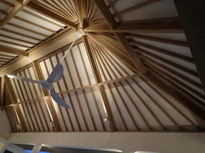 a wooden ceiling in a room with a ceiling fan at Villa Hujan in Seminyak