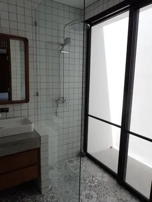 a bathroom with a shower and a sink at Villa Hujan in Seminyak