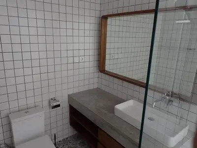 a bathroom with a toilet and a sink and a mirror at Villa Hujan 2 in Seminyak