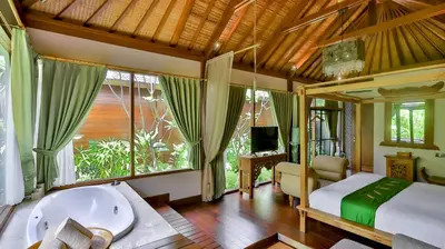 a bedroom with a tub and a bed and a window at DISINI Luxury Spa Villas-CHSE Certified in Seminyak