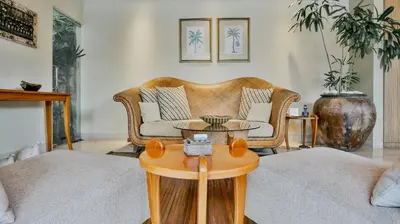 a living room with a couch and a table at DISINI Luxury Spa Villas-CHSE Certified in Seminyak