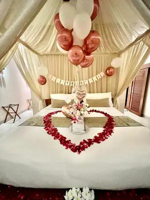 a bed with a heart made out of roses and balloons at DISINI Luxury Spa Villas-CHSE Certified in Seminyak