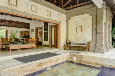 a patio with a pool in the center of a house at Villa Dewata One in Seminyak