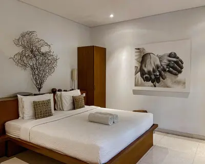 a bedroom with a large white bed in a room at Villa Chocolat Seminyak in Seminyak