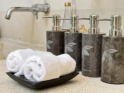 a group of four towels on a counter in a bathroom at Villa Chocolat Seminyak in Seminyak