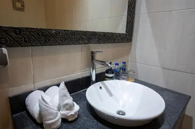 a bathroom sink with towels on a counter at Villa Katara in Seminyak