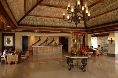 a lobby of a hotel with people sitting at tables at AYANA Resort Bali in Jimbaran