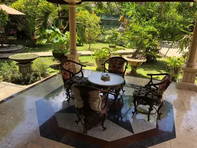 a table and chairs sitting on a patio at D'Kubu Legian in Legian