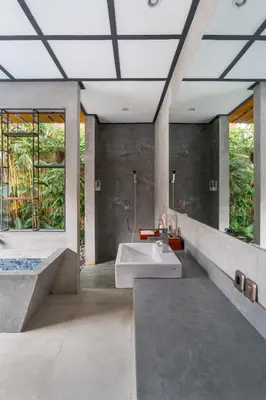 a bathroom with a sink and a shower and a tub at Vinna Villa Seminyak by The Wina Resorts in Kerobokan