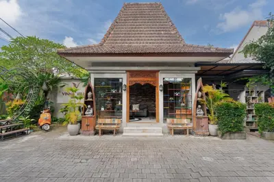 a small building with a book store with chairs at Vinna Villa Seminyak by The Wina Resorts in Kerobokan