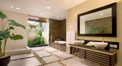 a bathroom with two sinks and a tub at The Kunja Villa-Hotel in Seminyak