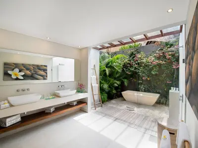 a bathroom with two sinks and a bath tub at The Layar - Designer Villas and Spa in Seminyak