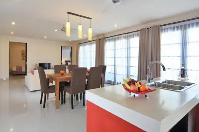 a kitchen and living room with a table and a dining room at Destiny Villas and Residence in Seminyak