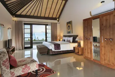 a bedroom with a bed and a living room at Destiny Villas and Residence in Seminyak