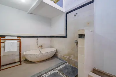a bathroom with a large stone tub in a room at MAHAYANA VILLA - 7Min Beach Access - 10min to Canggu in Canggu