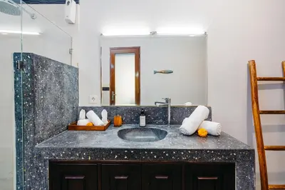 a bathroom with a sink and a mirror at MAHAYANA VILLA - 7Min Beach Access - 10min to Canggu in Canggu