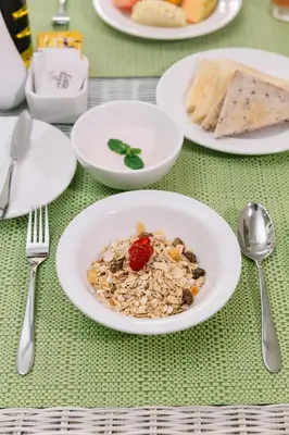 a plate of food on a table with plates of food at Kubu Benoa Guest House in Nusa Dua