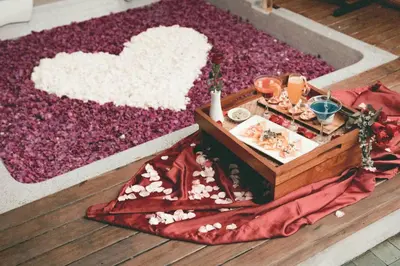 a wooden box with a tray of food on a rug at Berry Amour Romantic Villas in Seminyak