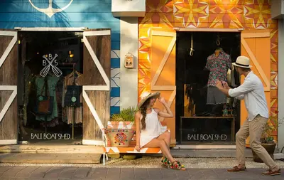 a man taking a picture of a woman in front of a store at Berry Amour Romantic Villas in Seminyak