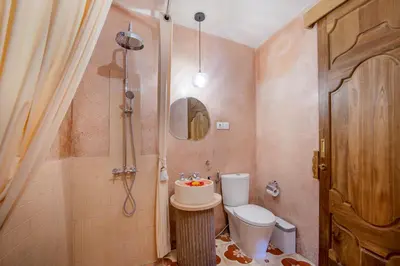 a small bathroom with a toilet and a shower at Villa Casa Adeline in Canggu