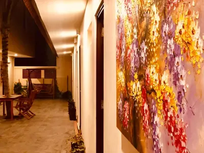 a painting hanging on a wall in a hallway at Familytel Bali in Jimbaran